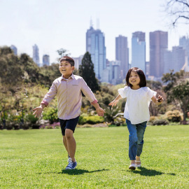 Boy and girl running in park in Melbourne